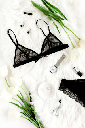 Flat lay stylish, sexy, black lingerie, accessories on a white background. Top view.の写真素材