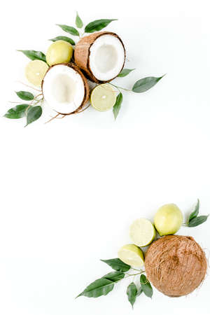 Creative pattern made of summer tropical fruits: coconut, lime and leaves ficus. Food concept. flat lay, top viewの写真素材
