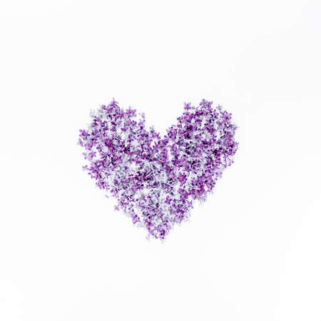 Heart symbol made of purple lilac. Valentines day background. Flat lay, top viewの写真素材