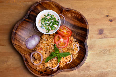 Tomato Rice in a Wooden Plateの写真素材