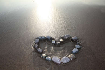 Heart made from pebbles on a beach の写真素材