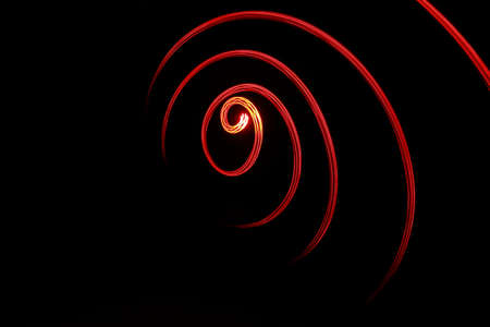 Spiral of red light - Made by painting with lightの写真素材