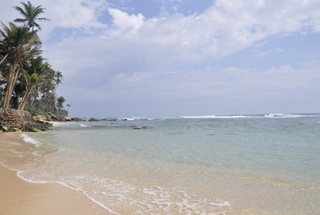 A bright sunny day at the beach at Polhena, Sri Lankaの写真素材