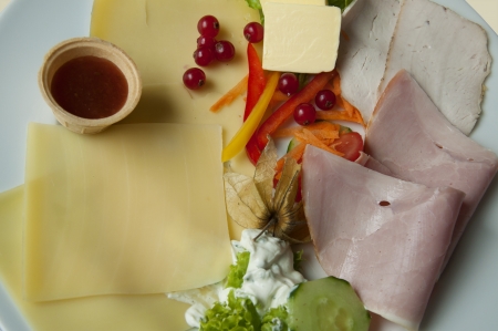 A Breakfast Platter with Ham, Salami, Cheese, Salad, Marmalade and Redcurrants in Germanyの写真素材