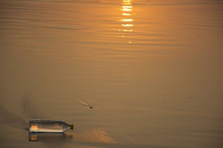 A plastic water bottle disposed off at the beachの写真素材