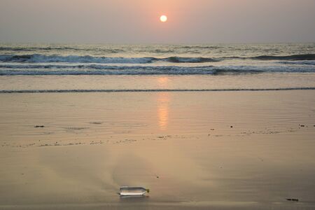 A plastic water bottle disposed off at the beachの写真素材
