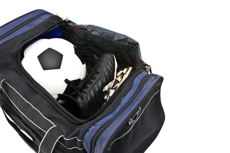 football and soccer shoe in open a sport bag on white backgroundの写真素材