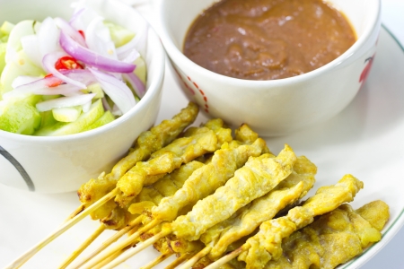 Satay thai food ,pork grill with peanut sauce and cucumber soup red onionの写真素材