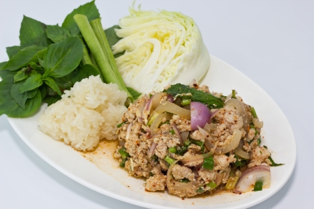 thai spicy minced pork with glutinous rice and vegetable on dishの写真素材