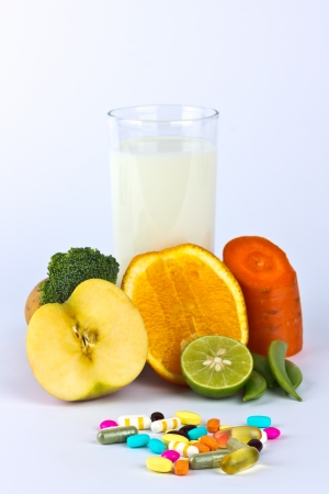 assorted fruit and vegetable and milk  with pillsの写真素材