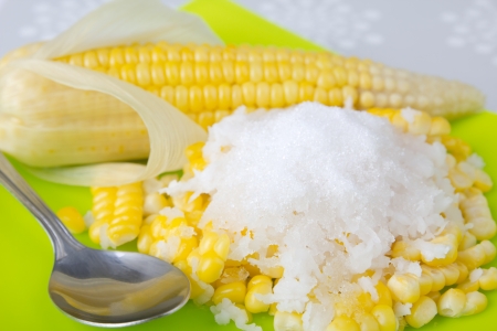 Corn boil strew with coconut   sugar on green dishの写真素材