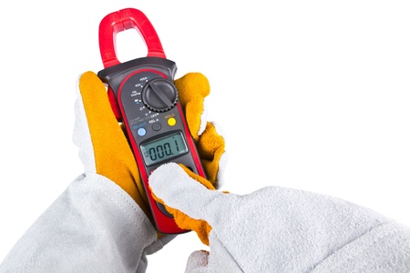 Electrician hand with gloves acting use a clamp multimeter  isolated on white background
