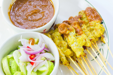 Grilled pork satay thai food with peanut sauce and cucumber soup red onionの写真素材