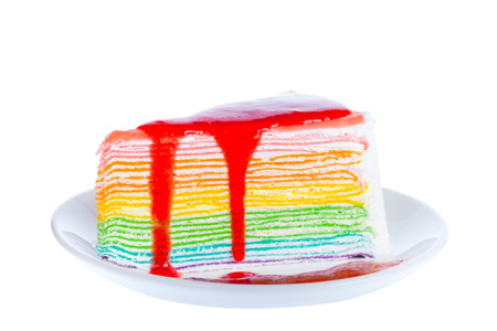 A piece of delicious multi color cake pour with strawberry sauce on a plate,Isolated on white backgroundの写真素材