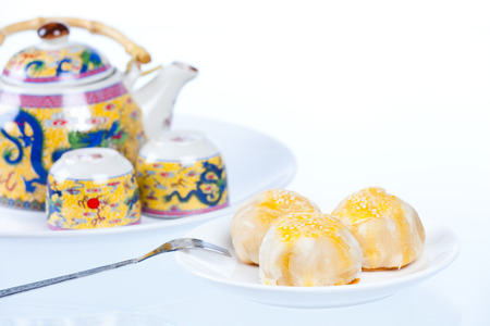 Chinese pastry or moon cake and teapot set, Traditional Thai cake on dish, Taiwan delicious dessert, shot in studio, on white backgroundの写真素材