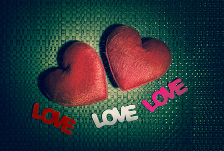 Two red hearts and three text "LOVE" on the texture background for a Valentine's day, love concept, black and white picture styleの写真素材