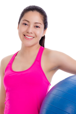 Healthy woman  beautiful asian thai girl smiling and holding a blue fitness ball isolated on white backgroundの写真素材