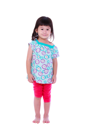 Full length portrait of a cute smiling girl poses for a picture. Isolated on white background. Studio shoot.の写真素材
