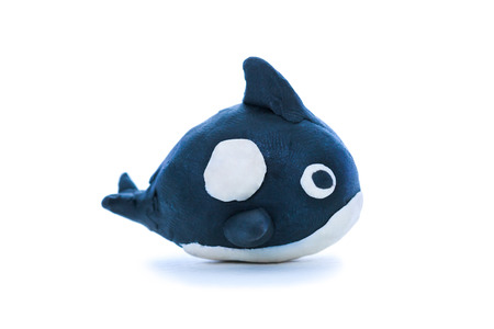 Creative clay model. Whale from children bright plasticine, on white background.