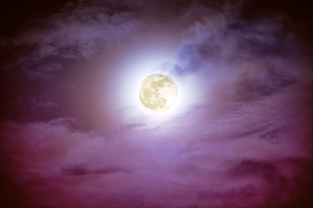 Attractive photo of background nighttime sky with cloud and bright full moon with shiny. Nightly sky with beautiful full moon. Outdoors at night. The moon were NOT furnished by NASA.の写真素材