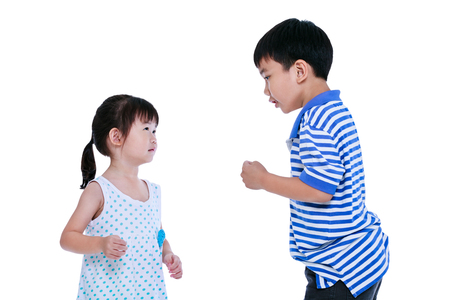 Quarreling conflict between the brother and sister. Asian kids are fighting, isolated on white background.の写真素材