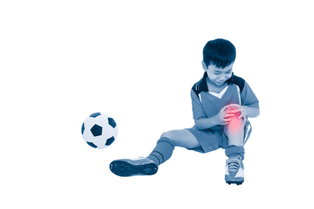 Sports injure. Youth asian soccer player with football in uniform injured at his knee. Isolated on white background. Full body. Color increase blue skin and red spot indicating location of pain.の写真素材