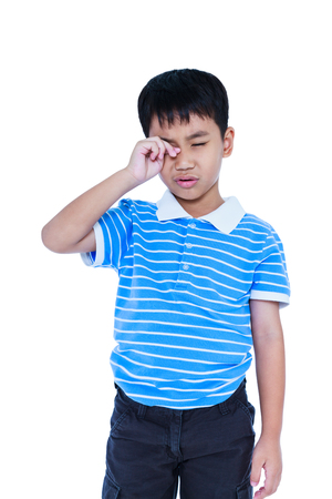 Eyes Pain. Asian child suffering from eyestrain, emotion feeling sign. Isolated on white background. Young boy stressed with a painful gesture, facial expression. Health care and medical concept.の写真素材