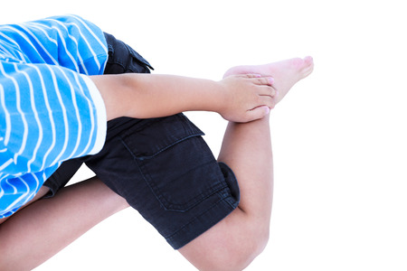 Child injured. Child injured at heel. Boy bruise with a painful gesture, isolated on white background. Human health care and problem concept. Studio shot.の写真素材