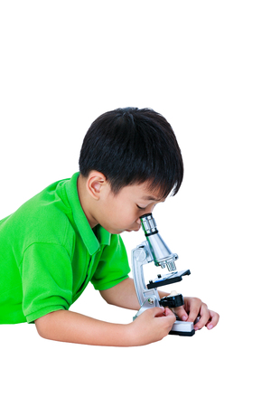 Asian child observed through a microscope biological preparations. Boy having education activities. Isolated on white background. Studio shot.の写真素材