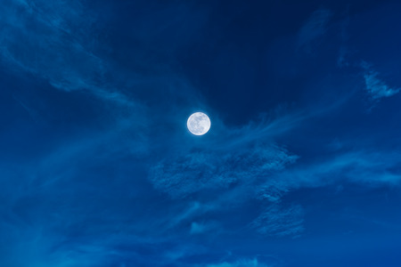 Beautiful cloudscape. Night sky with bright full moon and clouds. Serenity nature background, outdoor at nighttime. The moon taken with my own camera.の写真素材