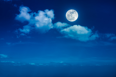 Beautiful skyscape. Landscape of night sky with clouds and bright full moon. Serenity nature background, outdoor at nighttime with moonlight. The moon taken with my own camera.の写真素材