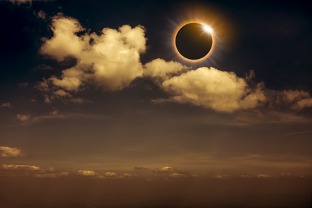 Scientific natural phenomenon. The Moon covering the Sun. Total solar and lunar eclipse with diamond ring effect glowing on sky. Beautiful nature and serenity landscape. Sepia tone.の写真素材