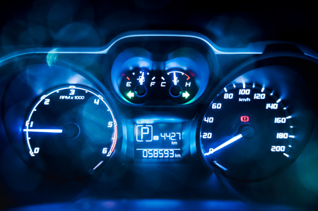 Dashboard. Close up of car speed meter. Car instrument panel, interior lights with colorful bokeh.の写真素材
