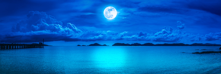 Beautiful panorama view of the sea. Colorful blue sky with cloud and bright full moon on seascape to night. Serenity nature background, outdoor at nighttime. The moon taken with my own camera.の写真素材