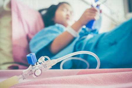 Closeup of hand adjust iv hose for patient.の写真素材