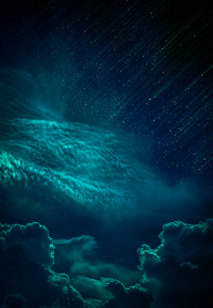 Beautiful vivid skyscape with many stars and meteor shower. Landscape of night sky with cloudy, serenity emerald green nature background, outdoor at nighttime.の写真素材