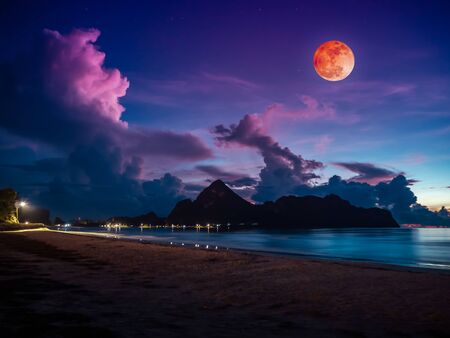 Beautiful view of the sea. Colorful blue sky with cloud and bright full moon on seascape to night. Serenity nature background outdoor at nighttime. The moon taken with my own camera.の写真素材