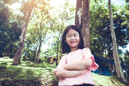 Portrait of a smiling little asian girl in the park.の写真素材