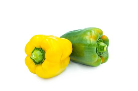 Two sweet yellow and green Peppers, isolated on whiteの写真素材