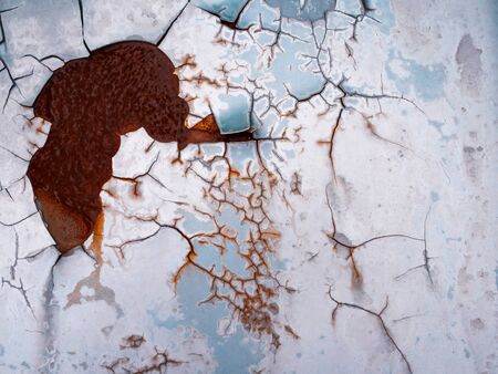 Worn rusty metal surface with paint flaking and cracking texture background.