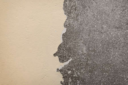 An old concrete wall with spotted and cracked surface for background.の写真素材