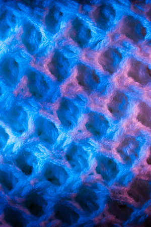 Close-up of fluffy soft textile. Abstract fabric with knit texture for background.