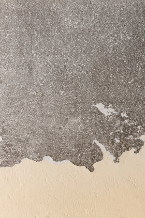 An old concrete wall with spotted and cracked surface for background.の写真素材