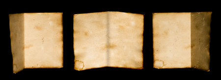 old brown vintage folded paper isolated on black background.の写真素材