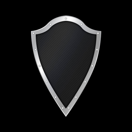 Black riveted shield on black background.の写真素材