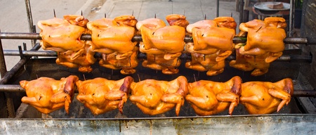 Rotating roast chicken, but not cookedの写真素材