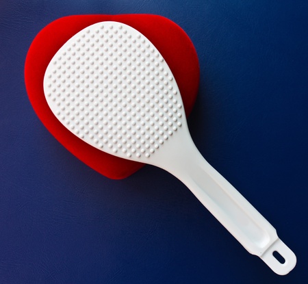 White plastic Scoop is placed on a heart shape.の写真素材