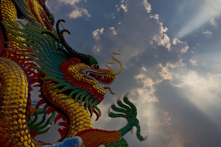 Statue of a golden Dragon a large sky conspicuously.の写真素材