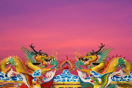 Golden Dragon statues, two on the roof gracefully.の写真素材