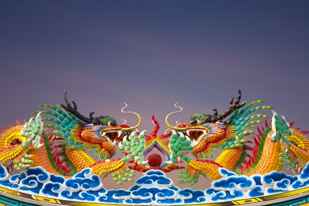 Golden Dragon statues, two on the roof gracefully.の写真素材